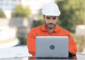 construction worker outside working on laptop