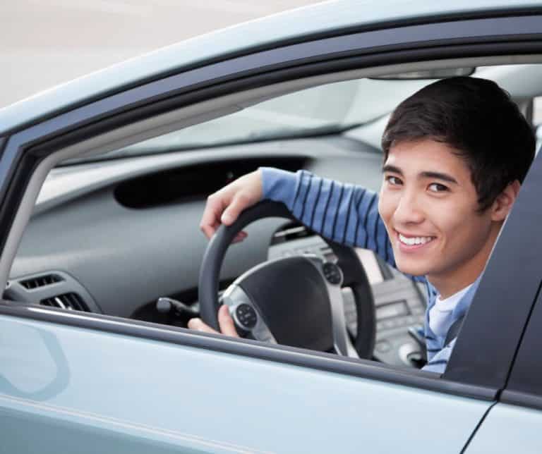 Teenager looking out of driver's side window.