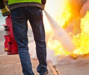 Person using fire extinguisher